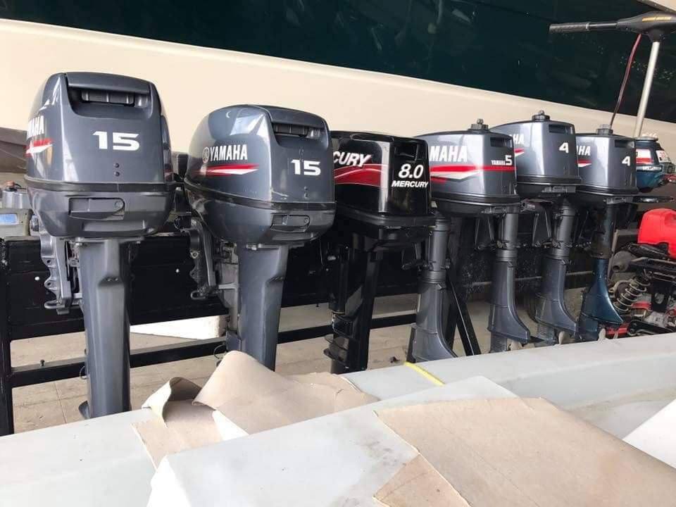 Lineup of small pre-owned outboard motors including Yamaha 15, Mercury 8 and Yamaha 5